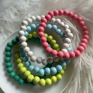 FIVE wooden bead bracelets
